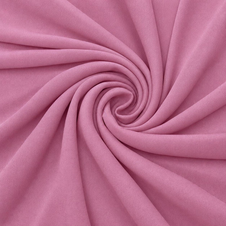 Støvet rosa silkegeorgette – stoffet formet som en spiral, der den creppede overflaten synes (bilde 1 av 3)