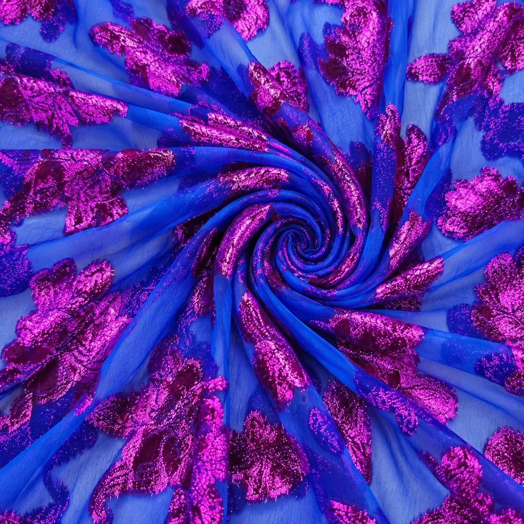 Kongeblå lurexchiffon med pink og lilla blomstermotiv – stoffet formet som en spiral (bilde 1 av 3)